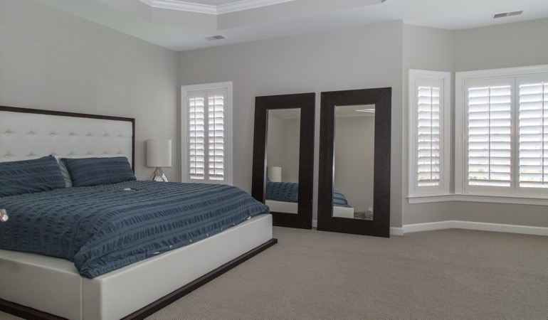 Polywood shutters in a minimalist bedroom in Phoenix.